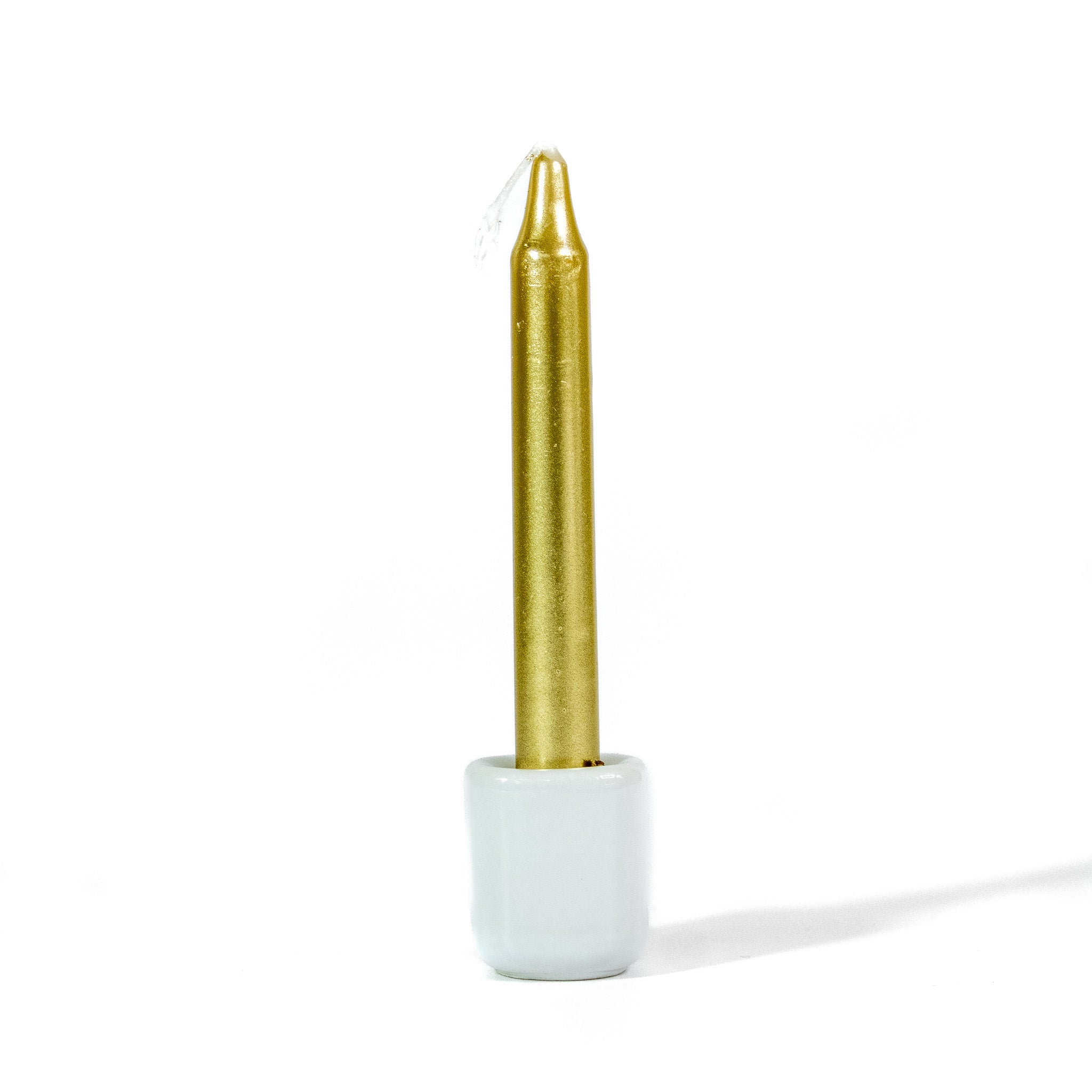 Small gold metallic chime spellwork candle in white chime holder against a white background.