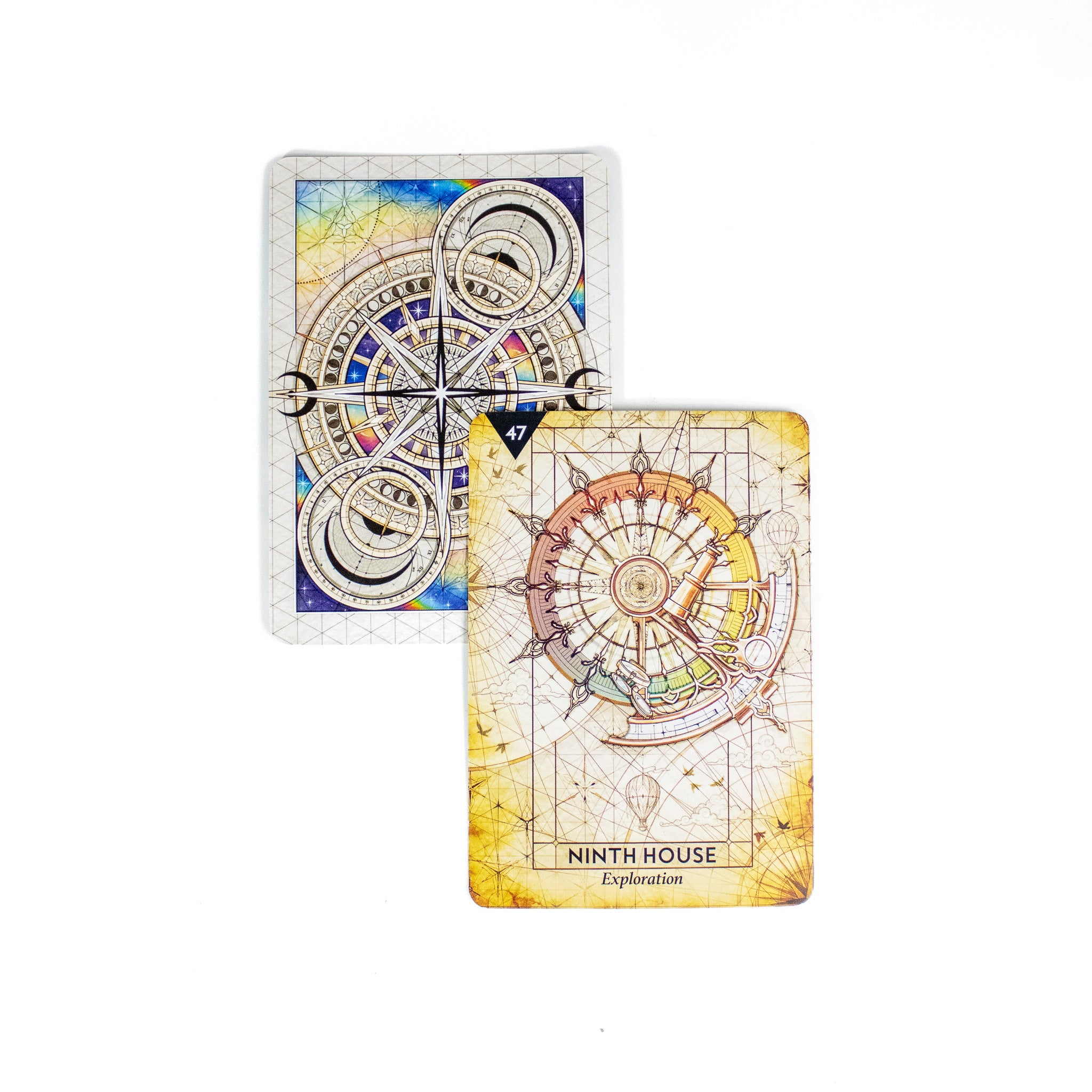 Nuveras Exploration card from the Starcodes Astro deck is golden in color and shows astrological instruments in a compass sphere. A second card behind it shows the back of the deck with compasses and sacred geometry.