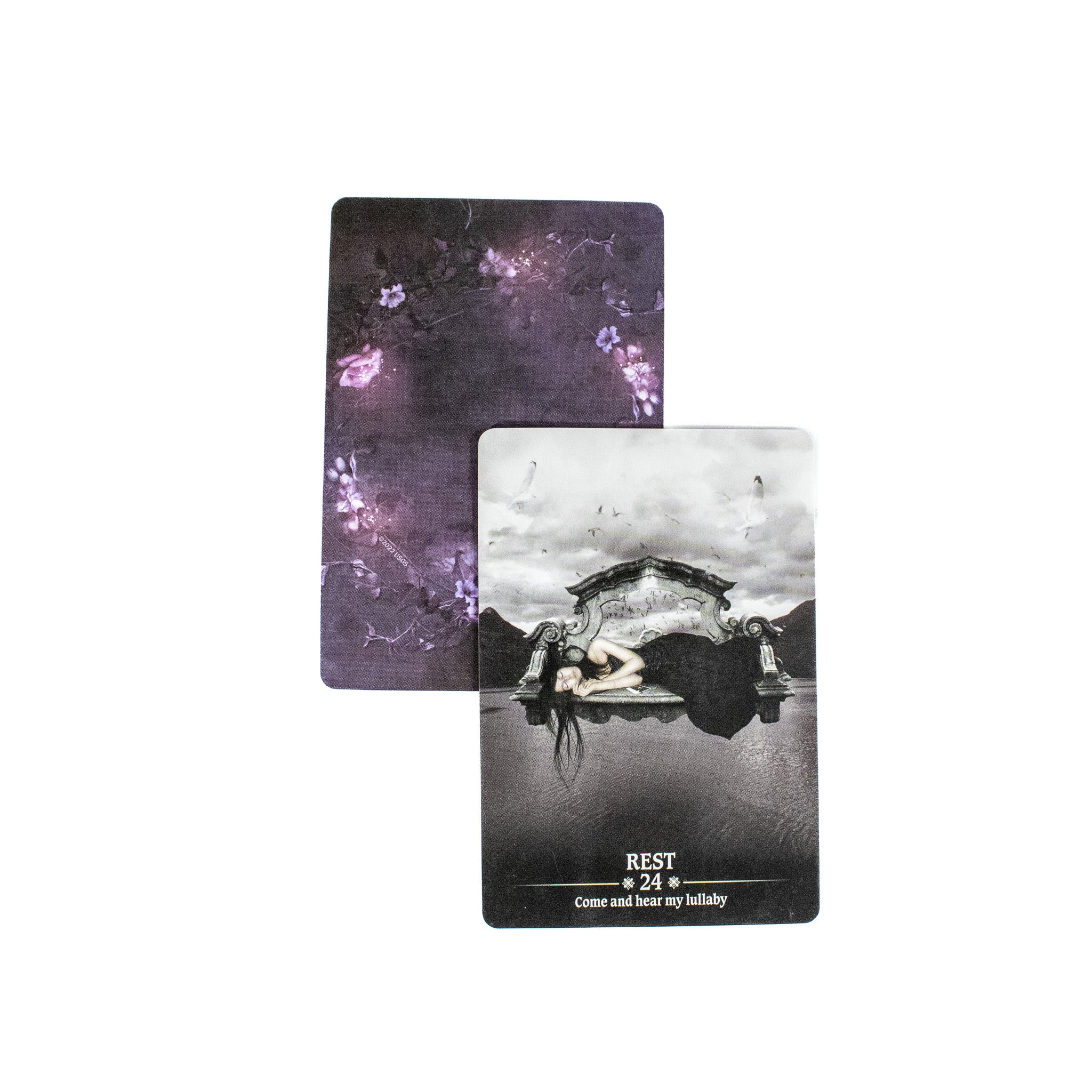 The Rest card shows a woman in a black dress lying on her side with water in front of her. The card is black and white. Behind it is another card showing the purple back of the deck. 
