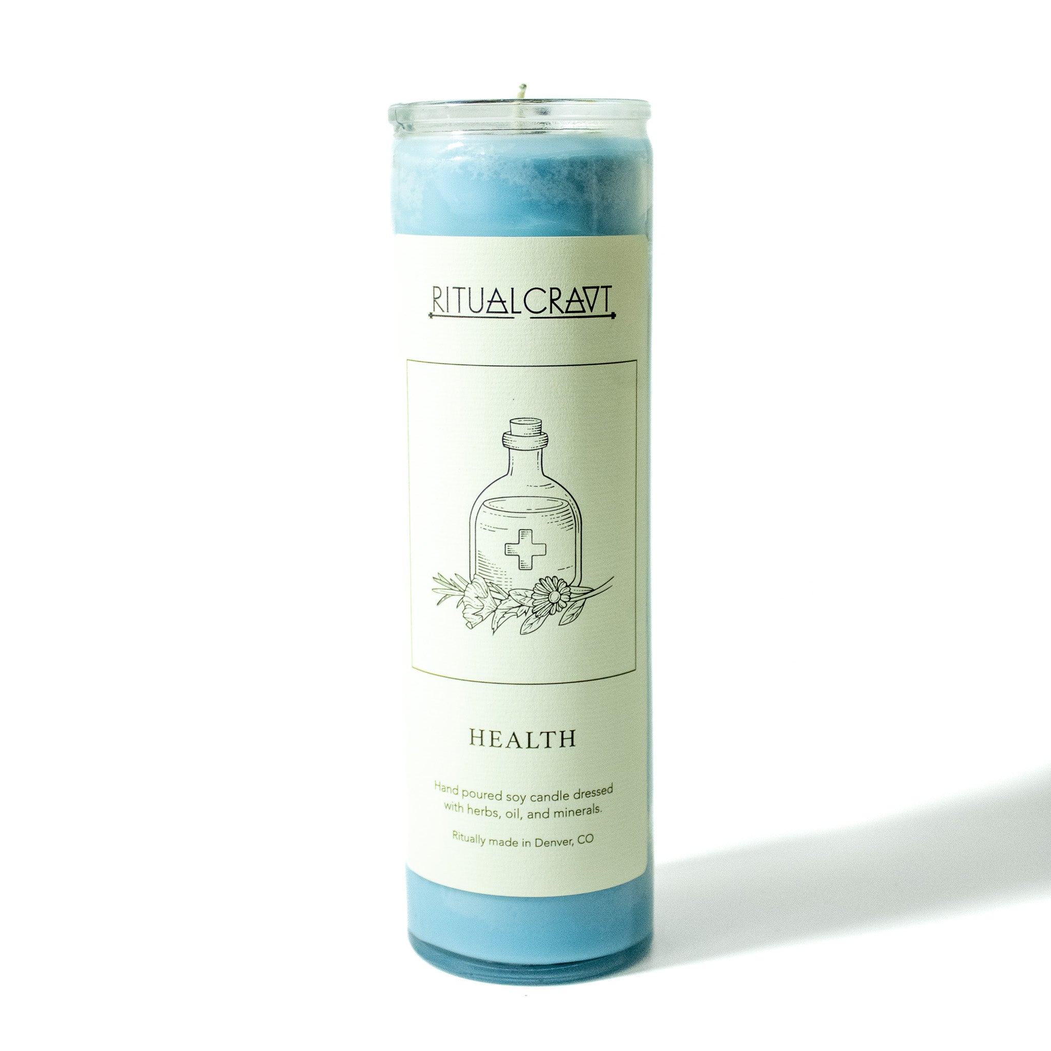 Light blue 7 day ritual spell candle in glass jar. Label is white and has a drawing of a medicine bottle with a cross on it and flowers at its base.