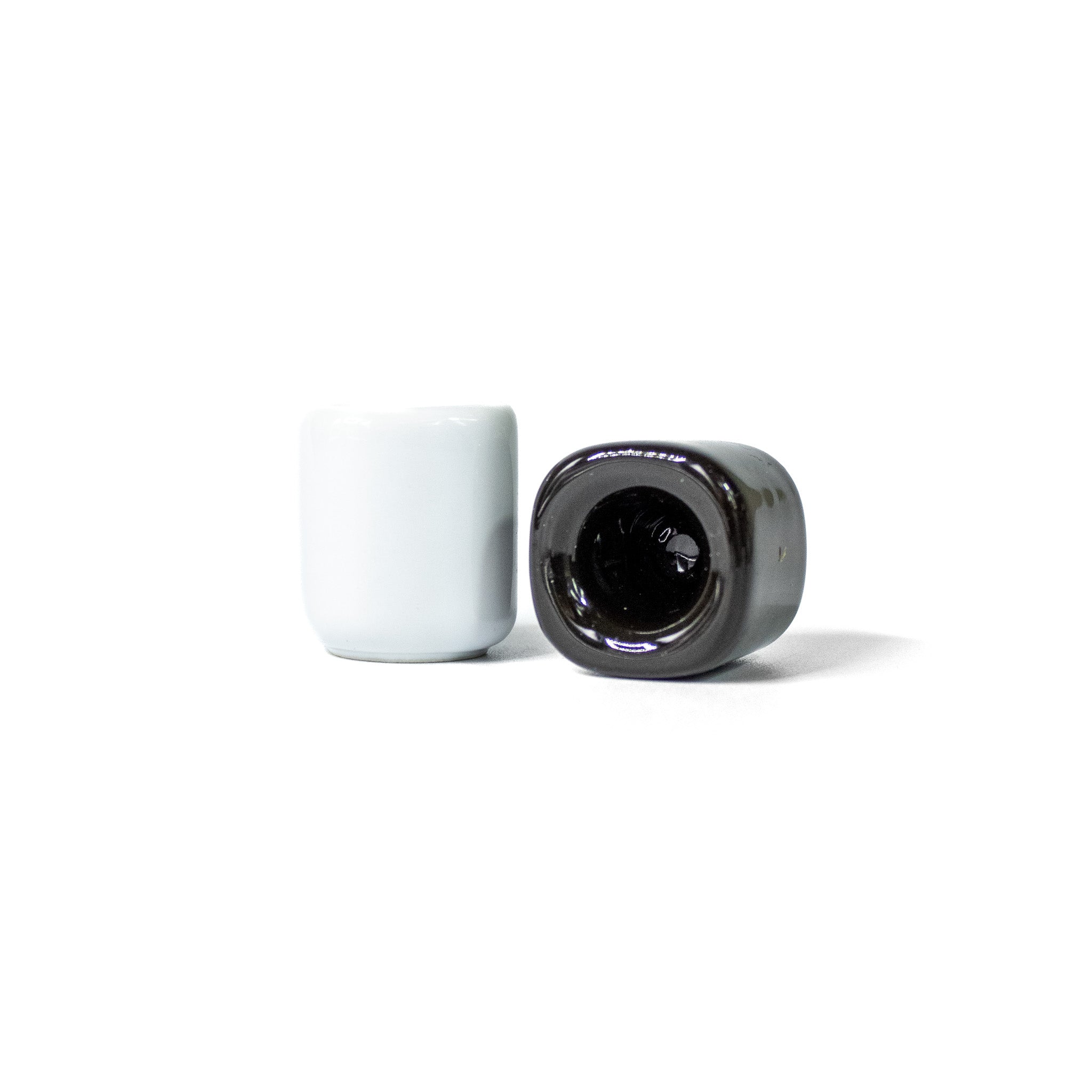 A white and black ceramic chime holder against a white background.