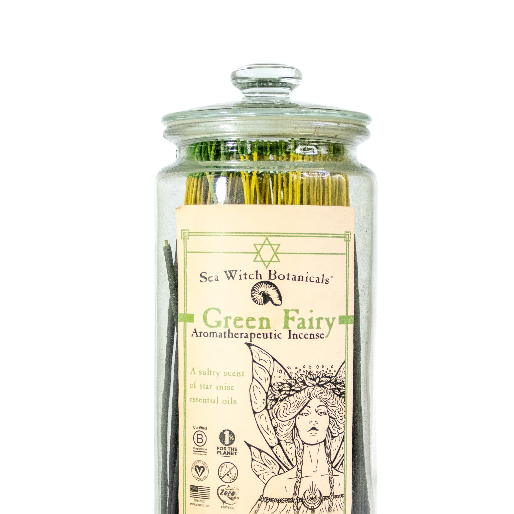 Glass apothecary jar with Sea witch green fairy incense. Incense sticks have green tips. Label has the drawing of a fairy. 