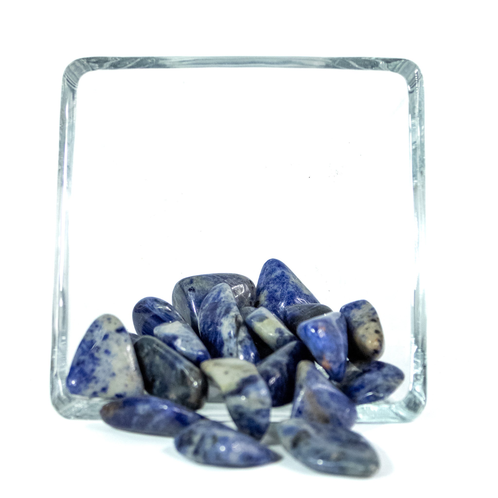Several blue sodalite tumbled pocket stones with natural variation in color including light and dark blue, greys, black and white. 