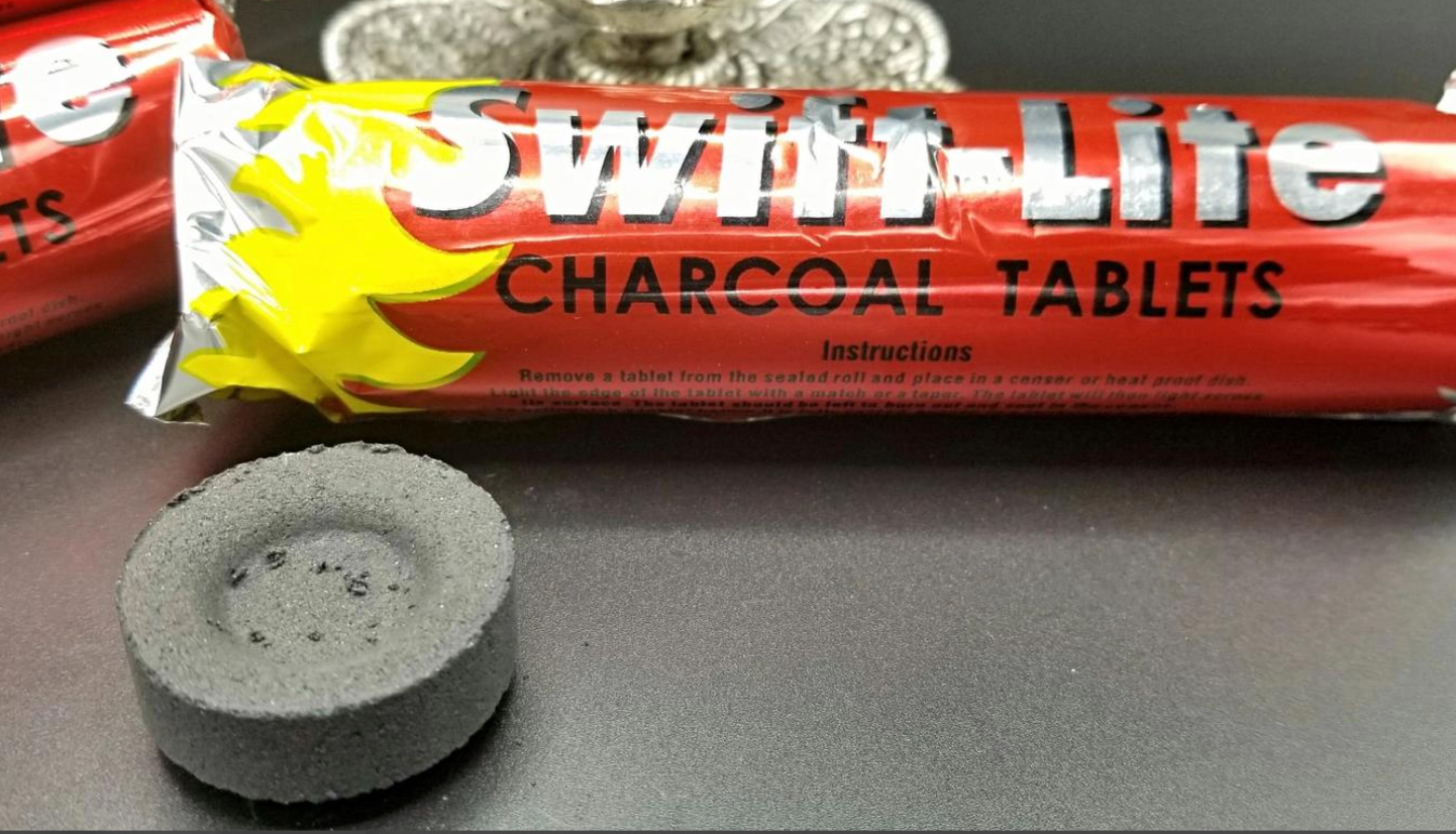 Charcoal briquette for burning loose incense and resin, shown with the red Swift Life package containing 10.