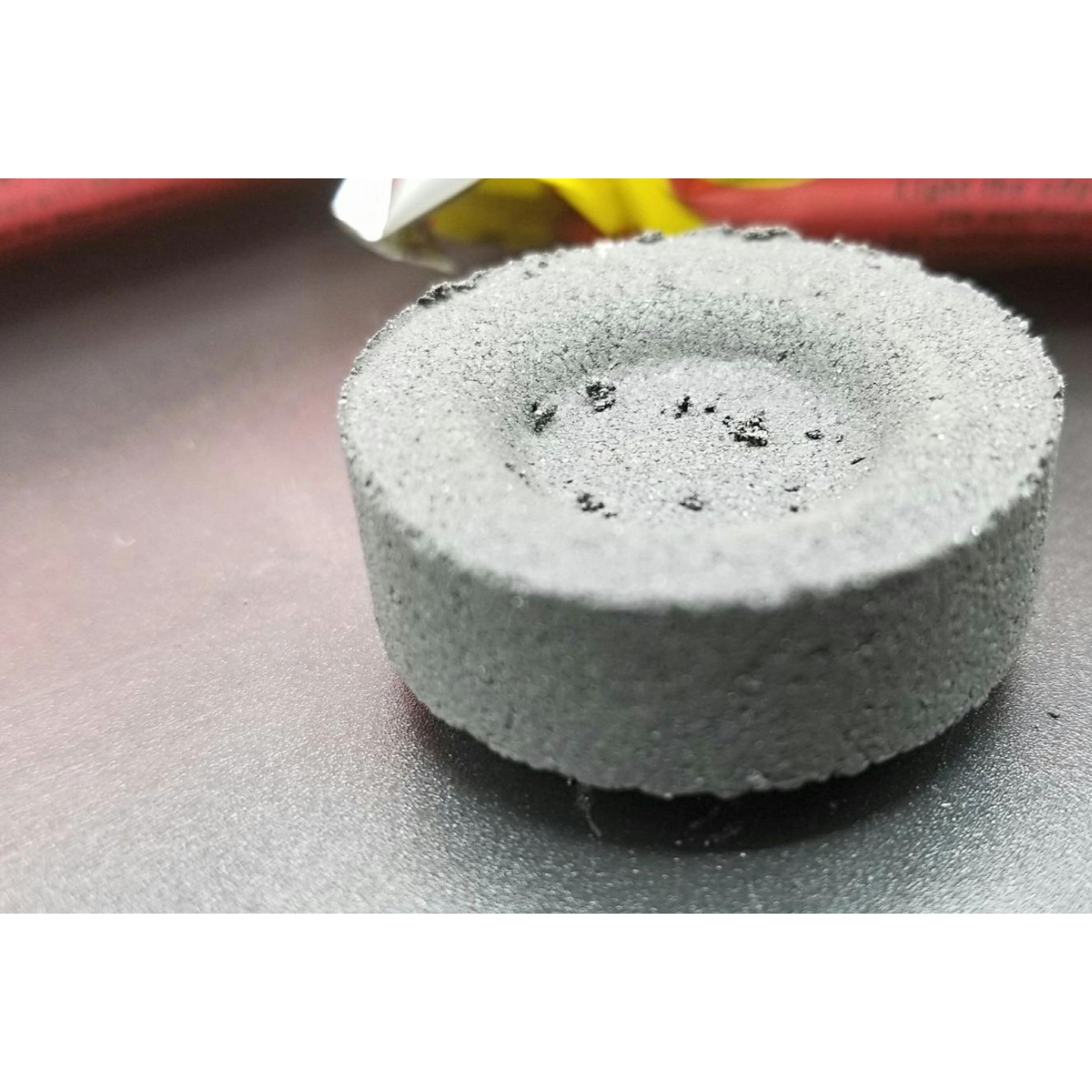 Grey charcoal briquette for incense and resins.